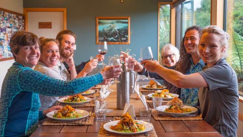 Our guests enjoying a meal together in Martins Bay