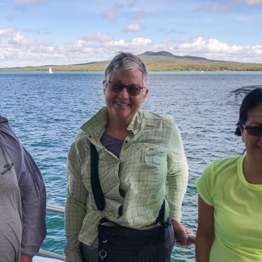 Group on the boat with Rangitoto Island in the background, Auckland New Zealand