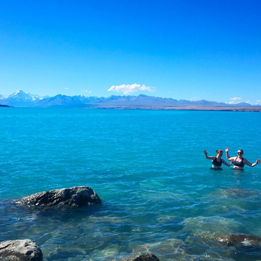 Having a dip in the glacial waters of Lake Pukaki. That's Aoraki/Mount Cook keeping watch!