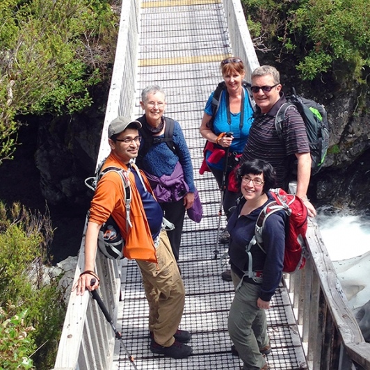 hikers at arthurs pass bridge new zealand